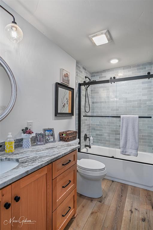 335 Coleman Loop Homer, LA 71040 - Photo 23 of 40 a bathroom with a granite countertop sink a toilet a mirror and shower