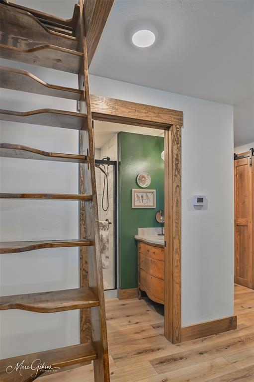 335 Coleman Loop Homer, LA 71040 - Photo 24 of 40 a view of a hallway with wooden floor and stairs