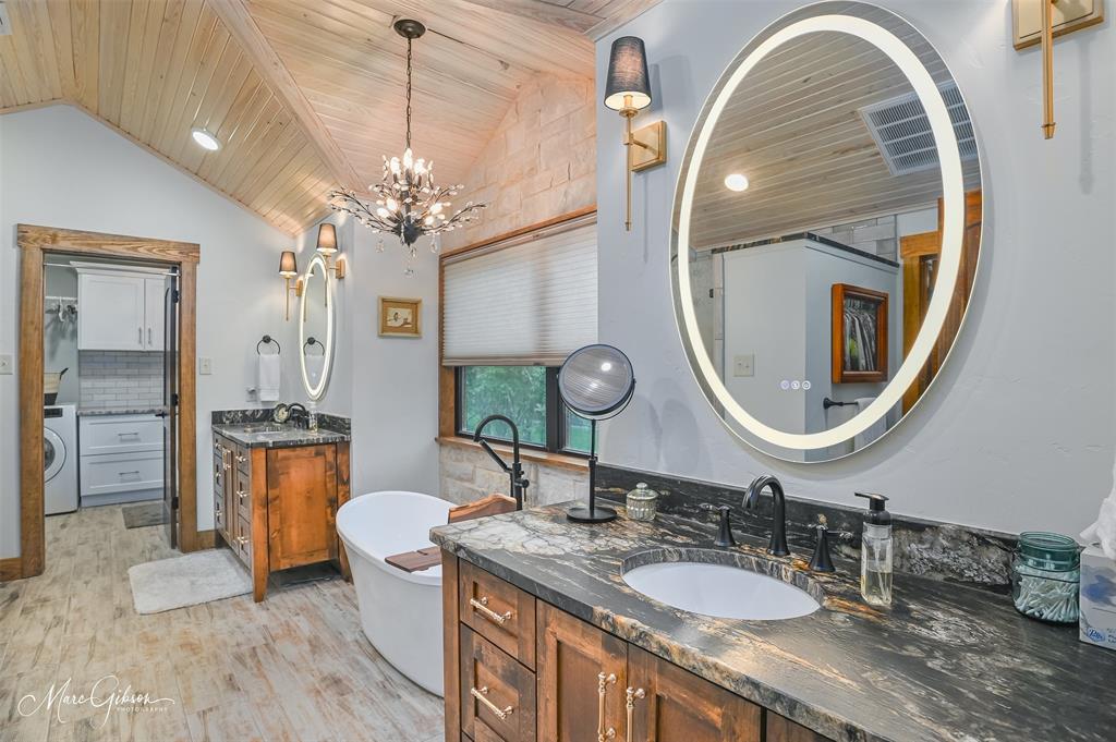 335 Coleman Loop Homer, LA 71040 - Photo 31 of 40 a bathroom with a granite countertop double vanity sink and a mirror