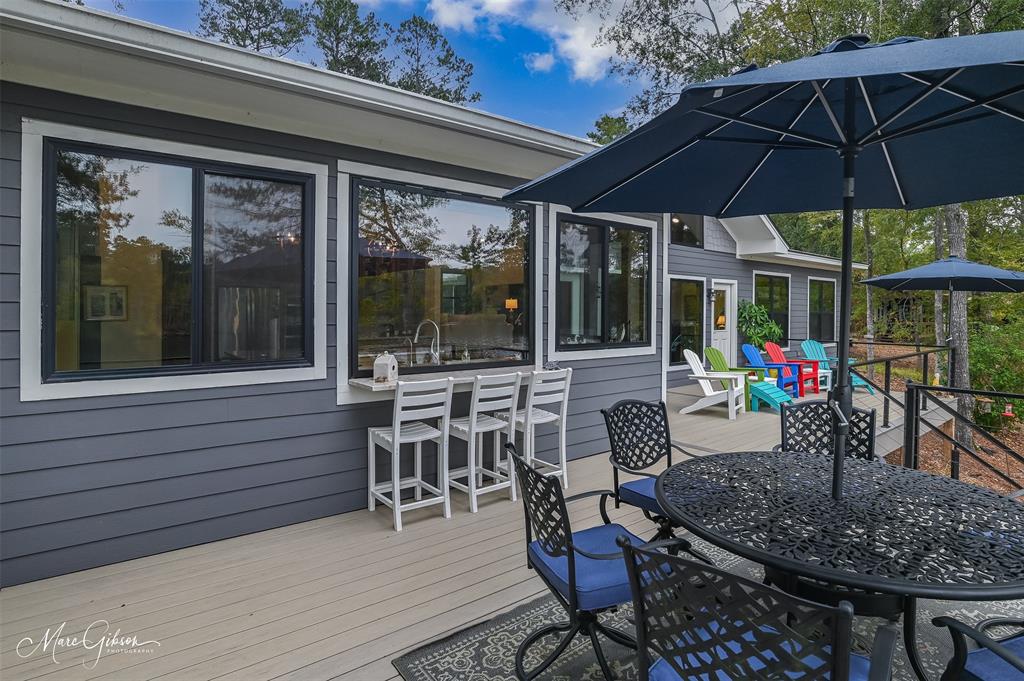 335 Coleman Loop Homer, LA 71040 - Photo 7 of 40 a view of a patio with a dining table and chairs under an umbrella