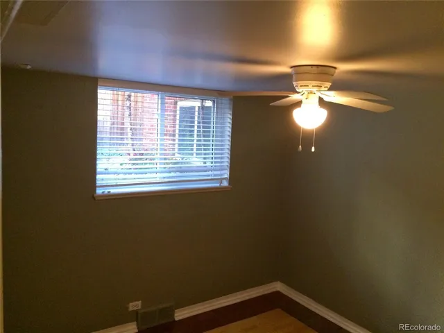 a view of a room with wooden floor and windows