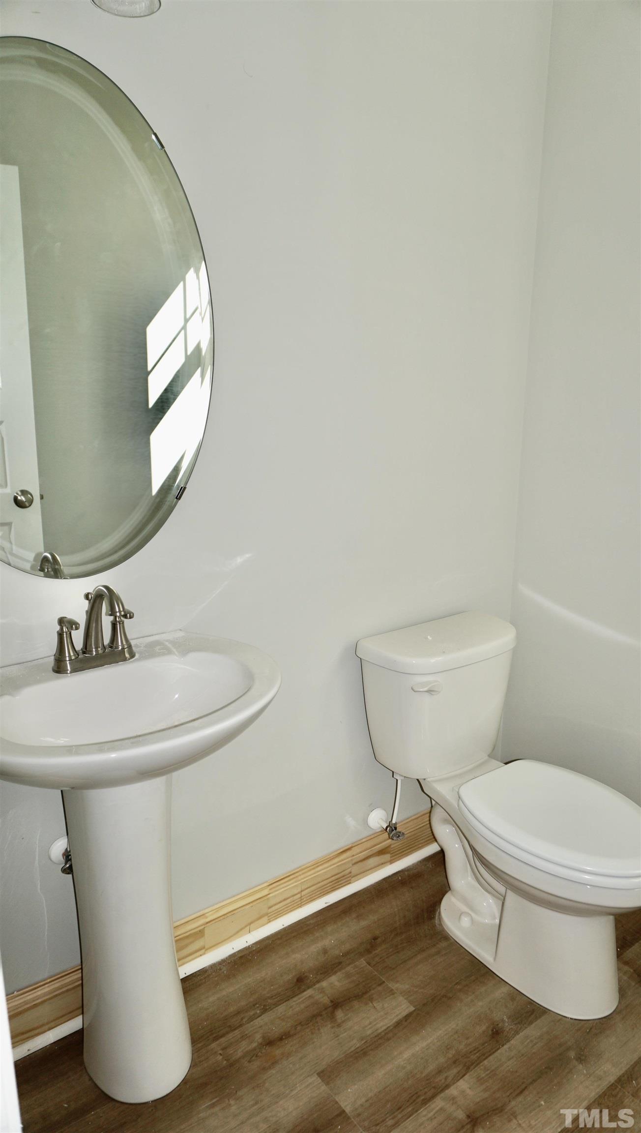 832 Mulberry Road Spring Hope, NC 27882 - Photo 16 of 26 a white toilet sitting next to a bathroom sink