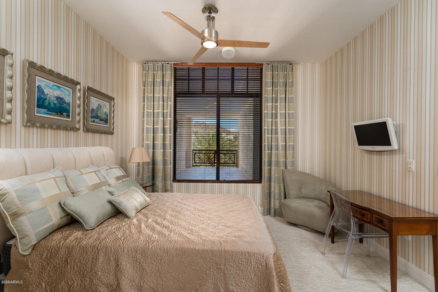 8 Biltmore Estate, Unit 302 Phoenix, AZ 85016 - Photo 12 of 21 a bedroom with a bed and a television