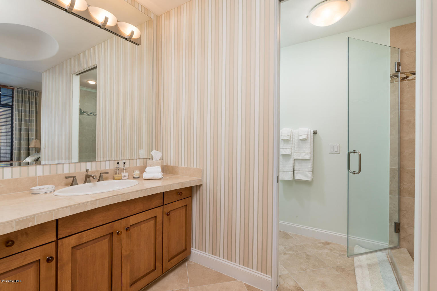 8 Biltmore Estate, Unit 302 Phoenix, AZ 85016 - Photo 13 of 21 a spacious bathroom with a double vanity sink a mirror and a shower