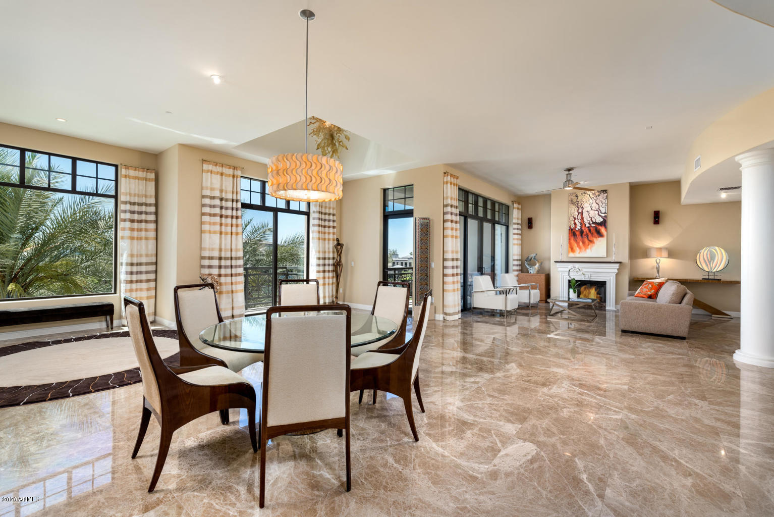 8 Biltmore Estate, Unit 302 Phoenix, AZ 85016 - Photo 2 of 21 a dining room with furniture a chandelier and a rug