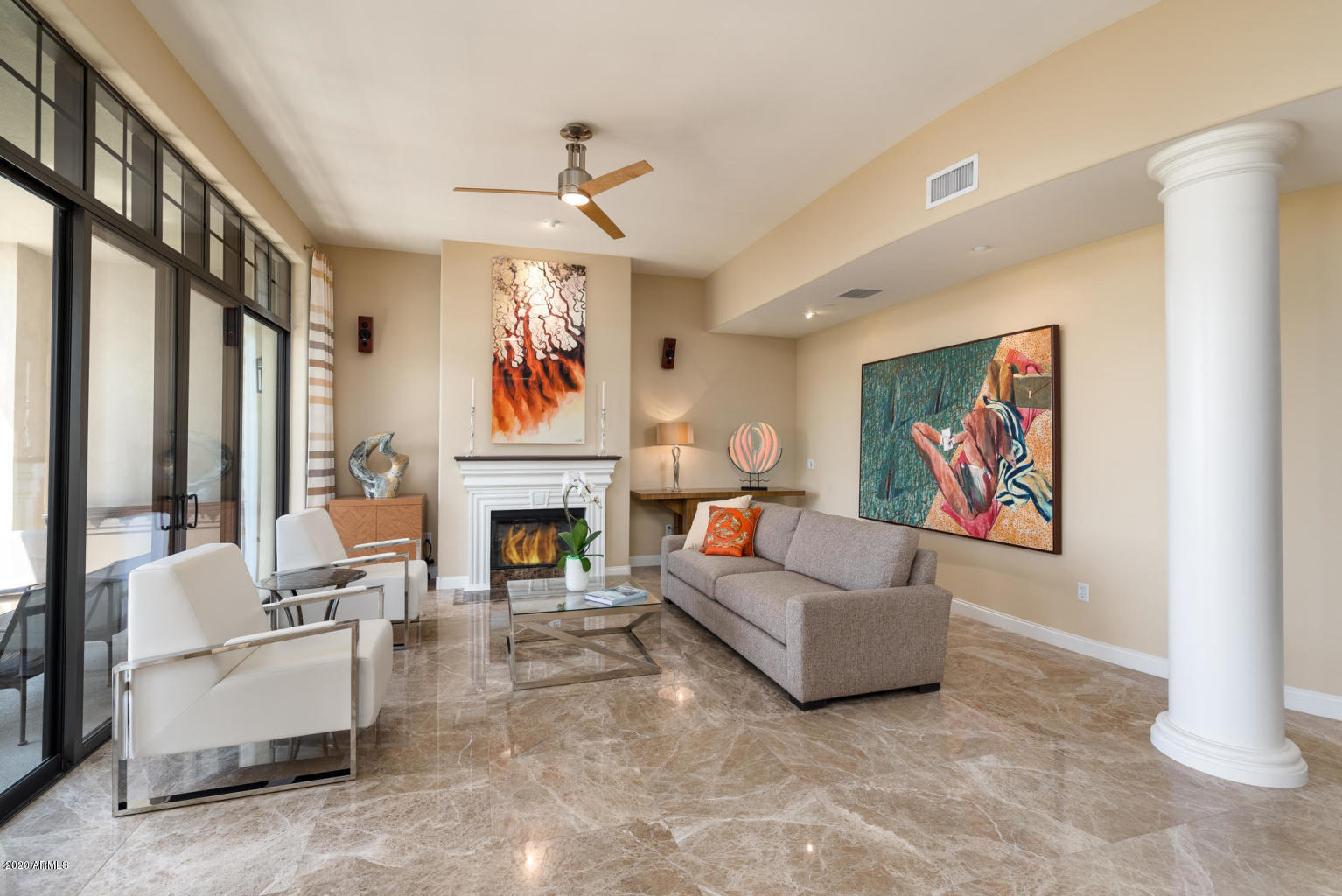 8 Biltmore Estate, Unit 302 Phoenix, AZ 85016 - Photo 7 of 21 a living room with furniture a fireplace and a chandelier