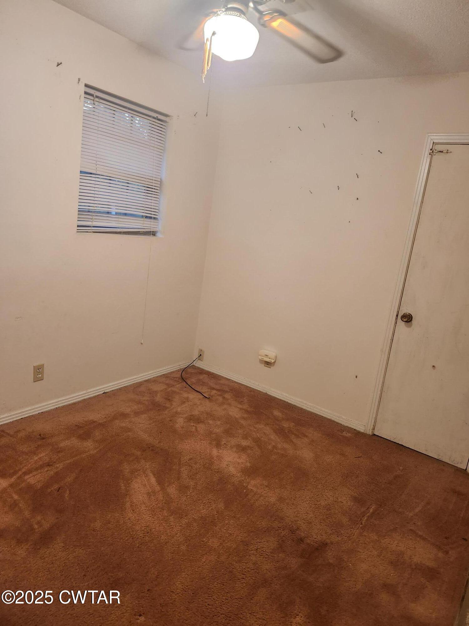 705 George Street Trenton, TN 38382 - Photo 11 of 15 an empty room with a workbench