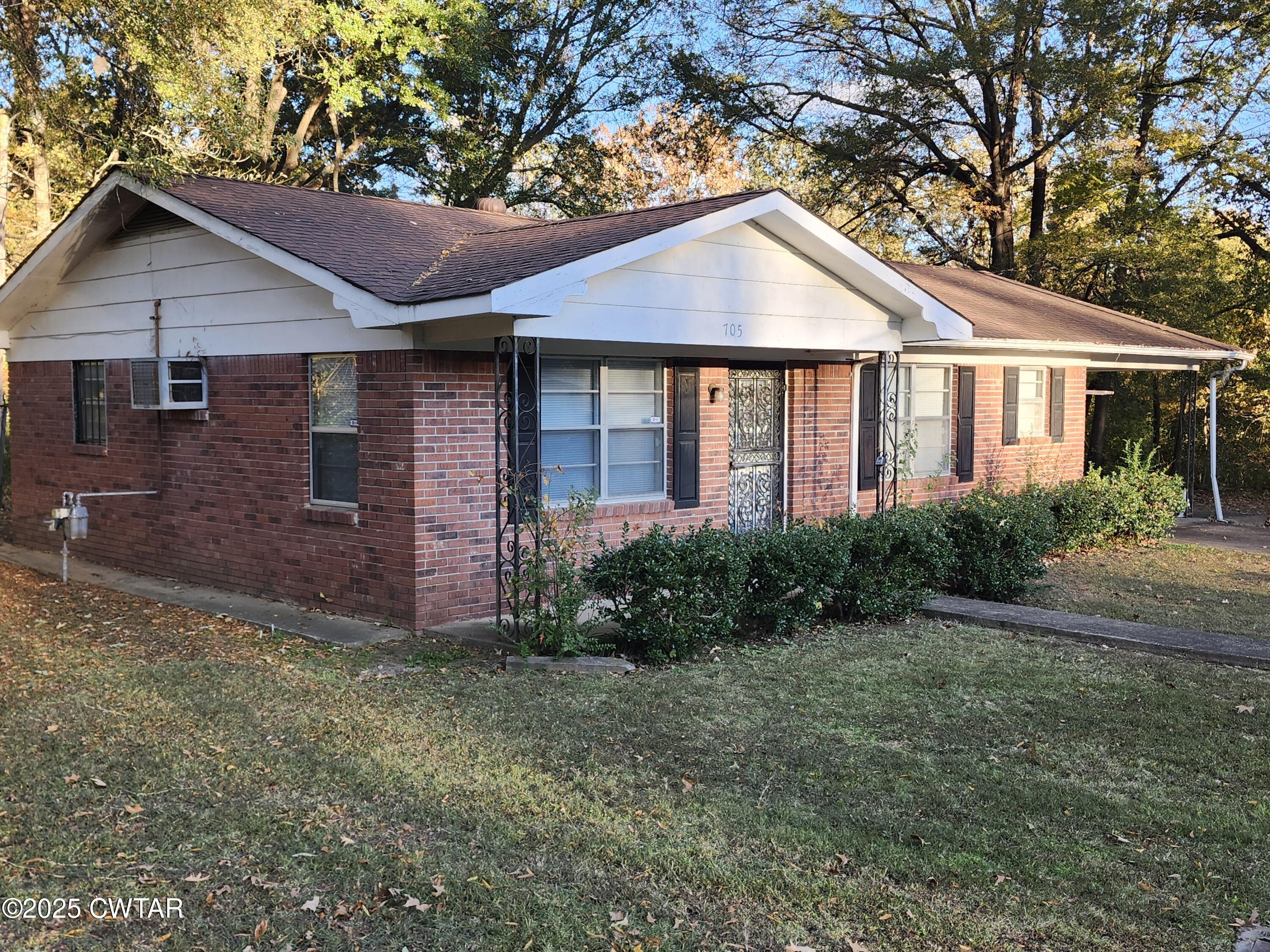 705 George Street Trenton, TN 38382 - Photo 2 of 15 a front view of a house with garden