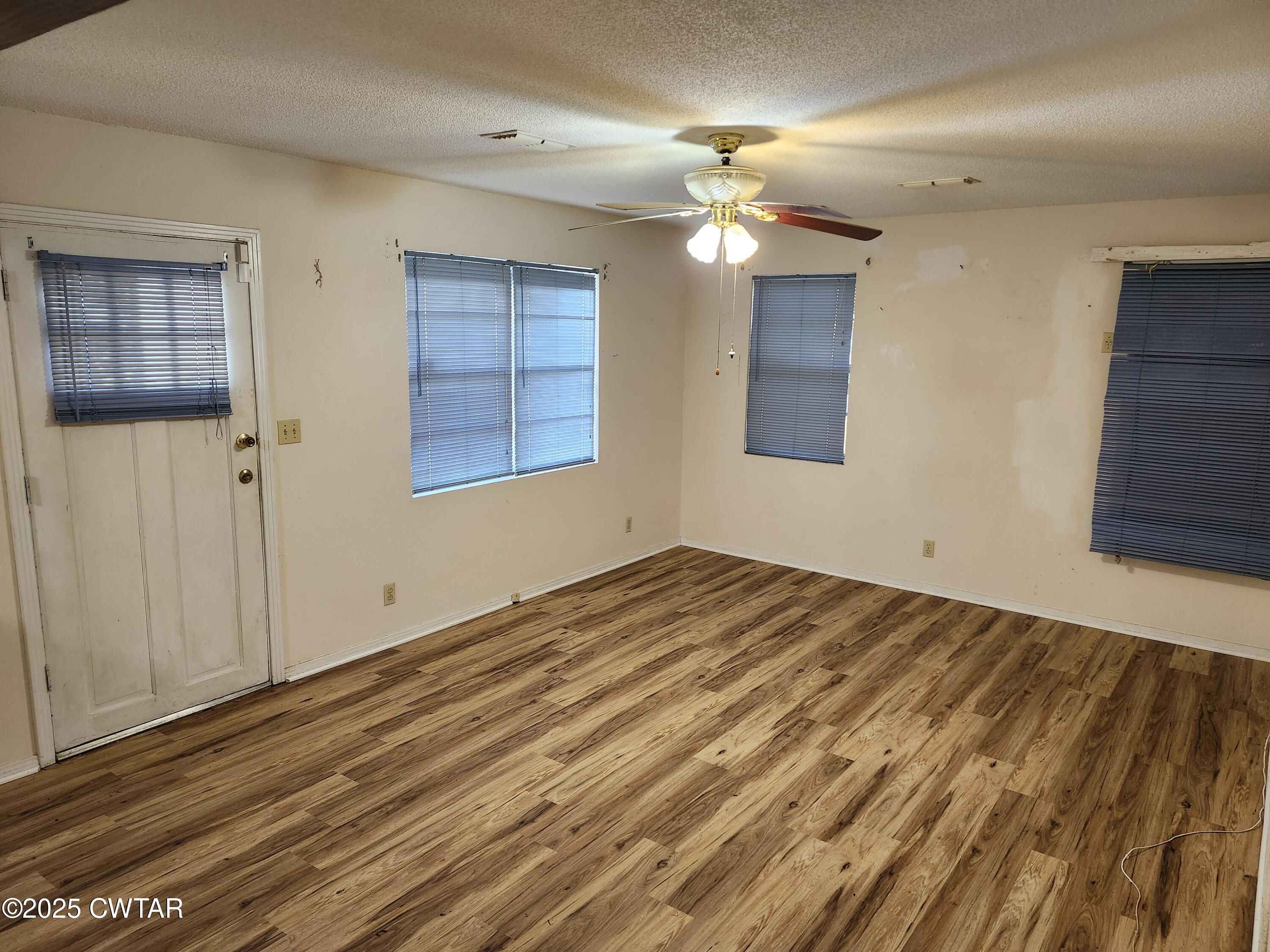 705 George Street Trenton, TN 38382 - Photo 4 of 15 a view of empty room with wooden floor