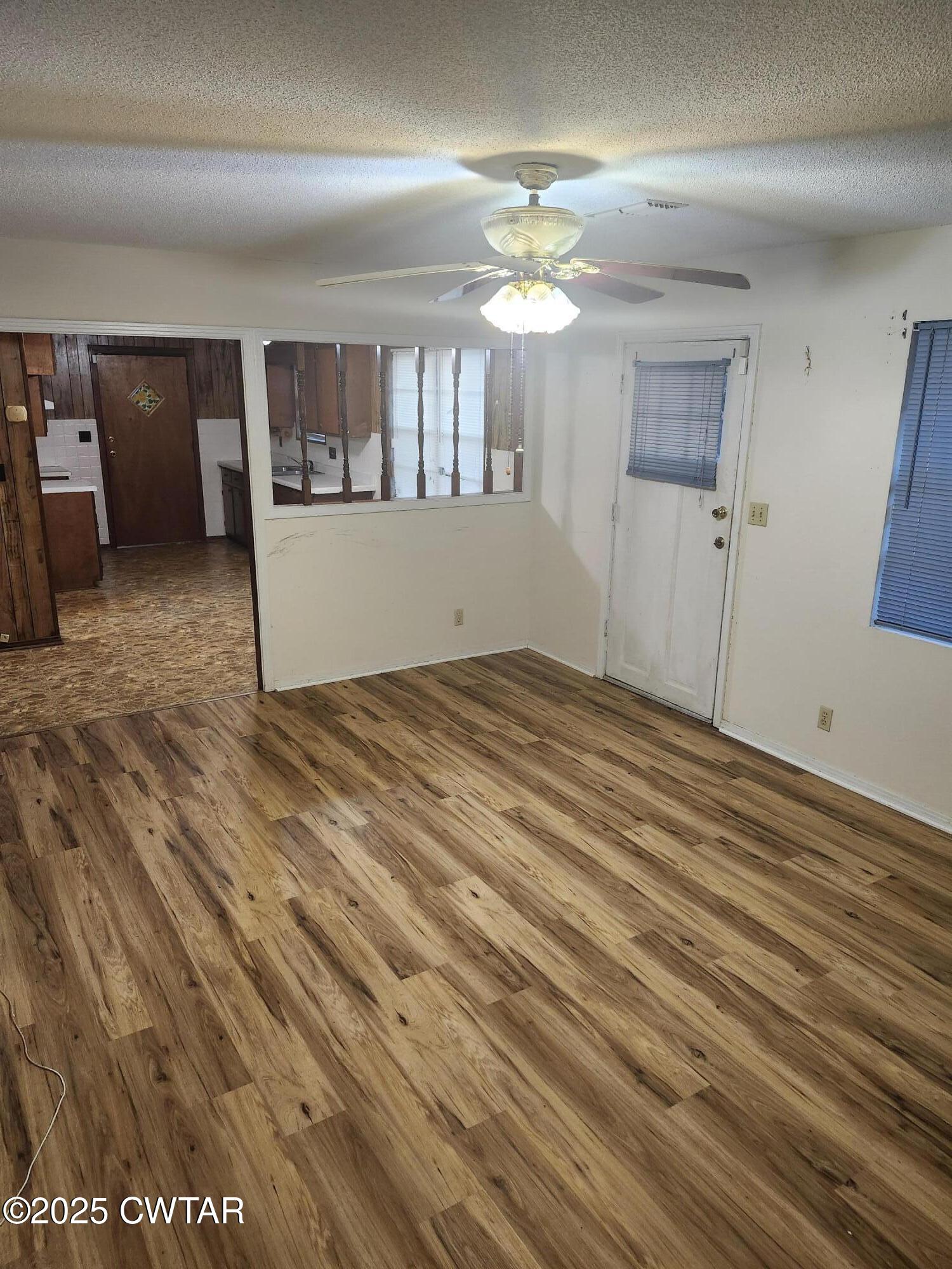 705 George Street Trenton, TN 38382 - Photo 5 of 15 wooden floor in an empty room with a window