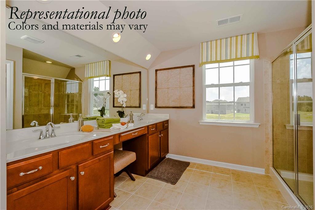 79169 Ridgehaven Road, Unit 152 Lancaster, SC 29720 - Photo 4 of 9 a spacious bathroom with a granite countertop sink mirror and a shower