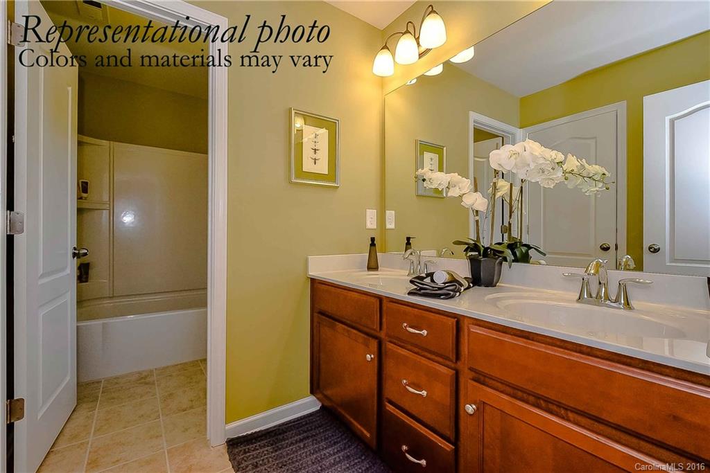 79169 Ridgehaven Road, Unit 152 Lancaster, SC 29720 - Photo 6 of 9 a bathroom with a double vanity sink a mirror and a shower