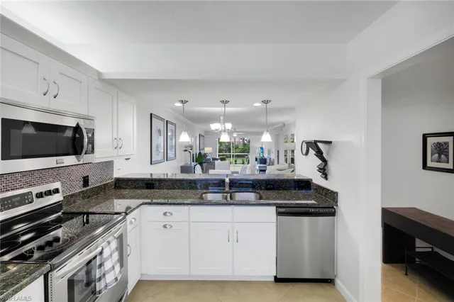a kitchen with a sink and a stove top oven