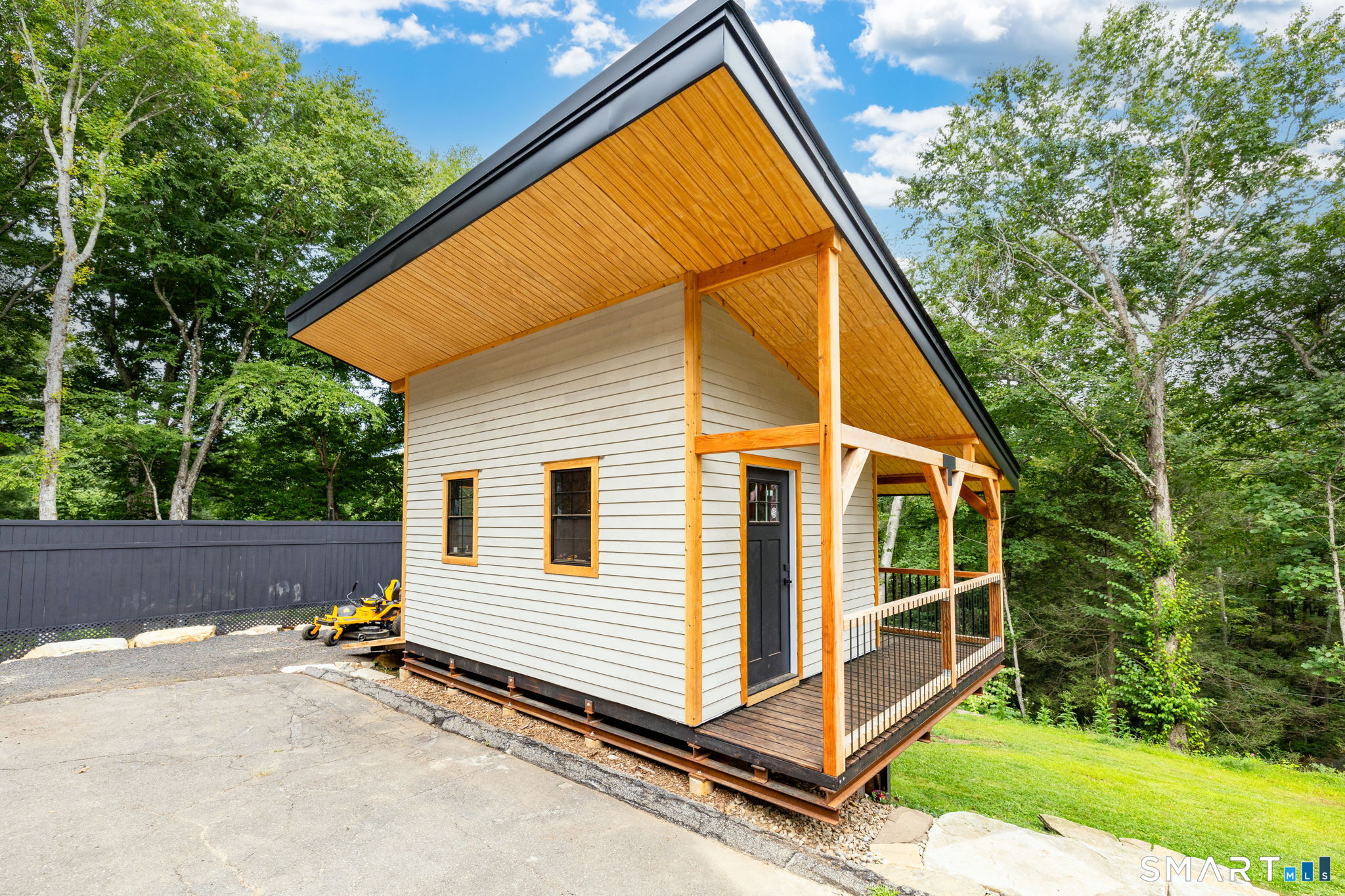 1386 Cedar Swamp Road Coventry, CT 06238 - Photo 4 of 39 Custom-built I-beam structure featuring cedar beams, decorative gussets, cedar siding ready for your choice of paint color, and a durable black standing-seam metal roof extending over the wrap-around porch.