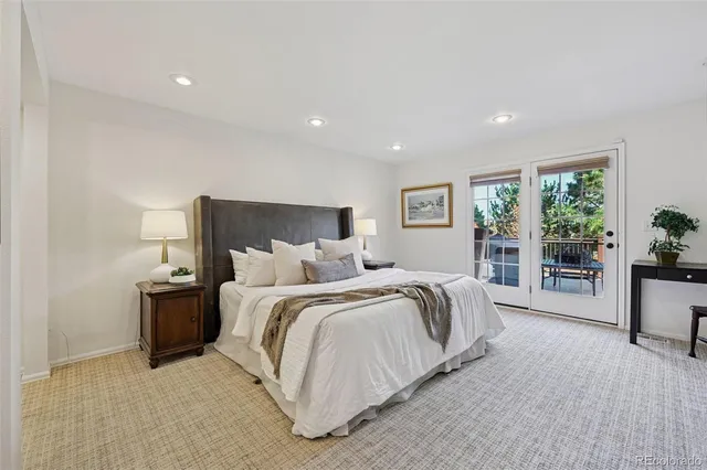 a spacious bedroom with a large bed and a large window