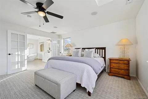 a spacious bedroom with a bed and ceiling fan