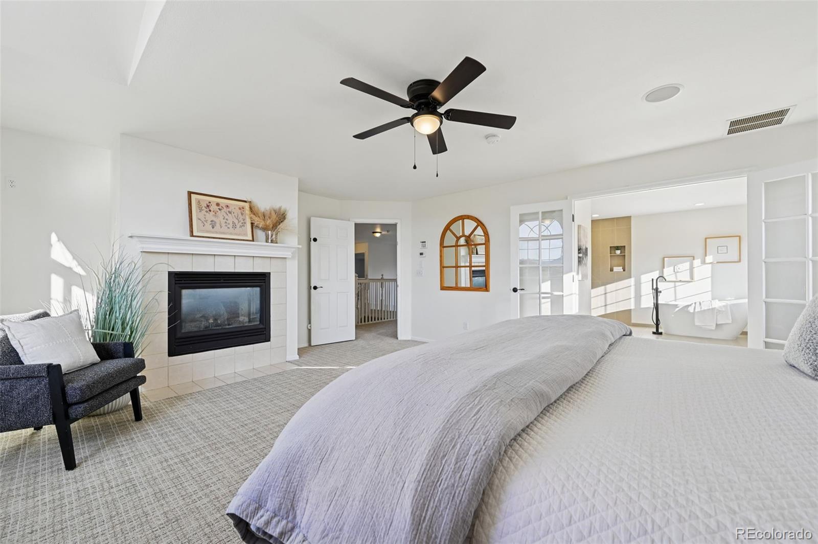 5575 Butler Court Colorado Springs, CO 80918 - Photo 21 of 47 a spacious bedroom with a bed and a fireplace
