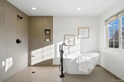 a bathroom with a bathtub and shower