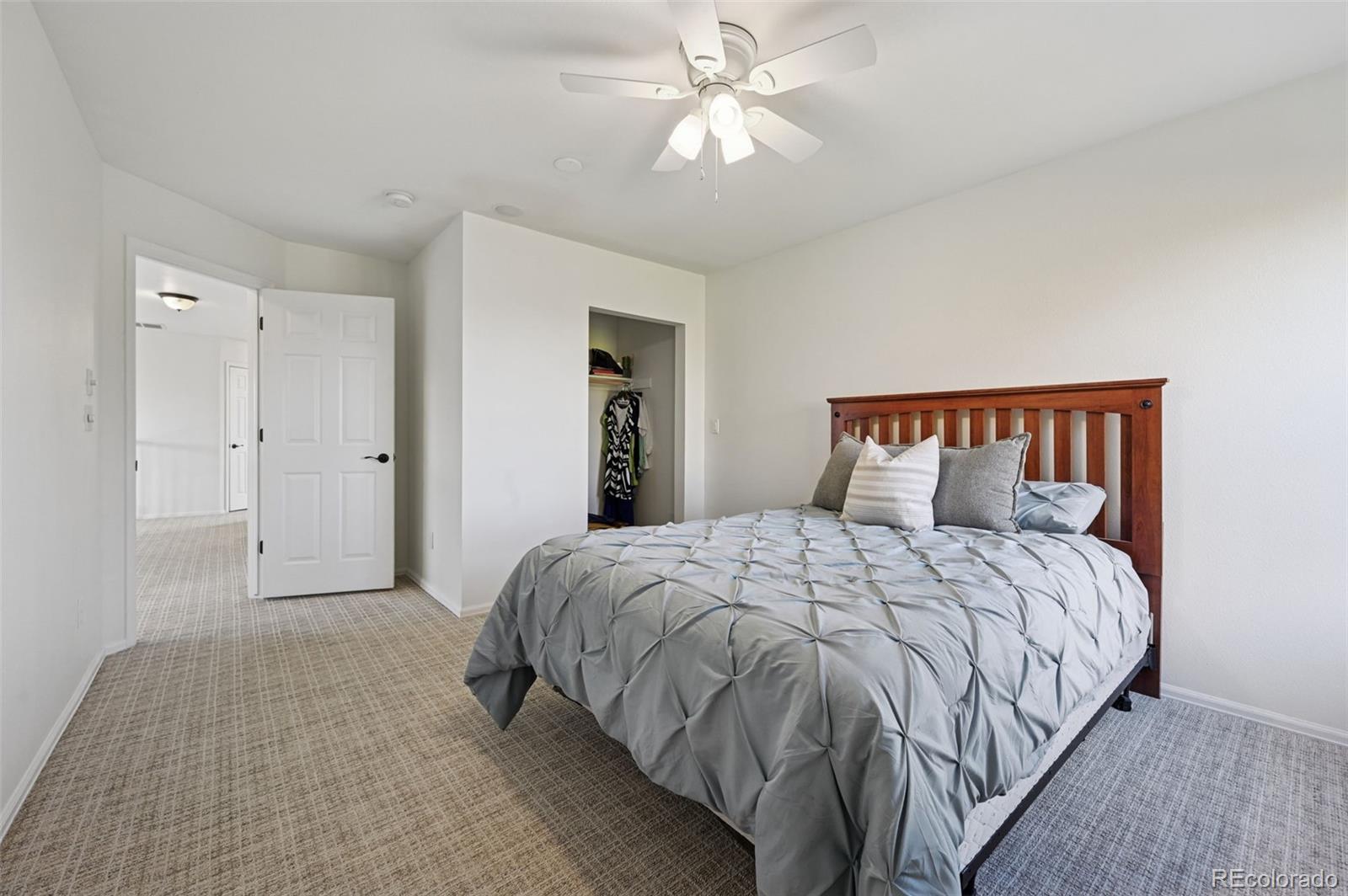 5575 Butler Court Colorado Springs, CO 80918 - Photo 30 of 47 a bedroom with a bed and a chandelier