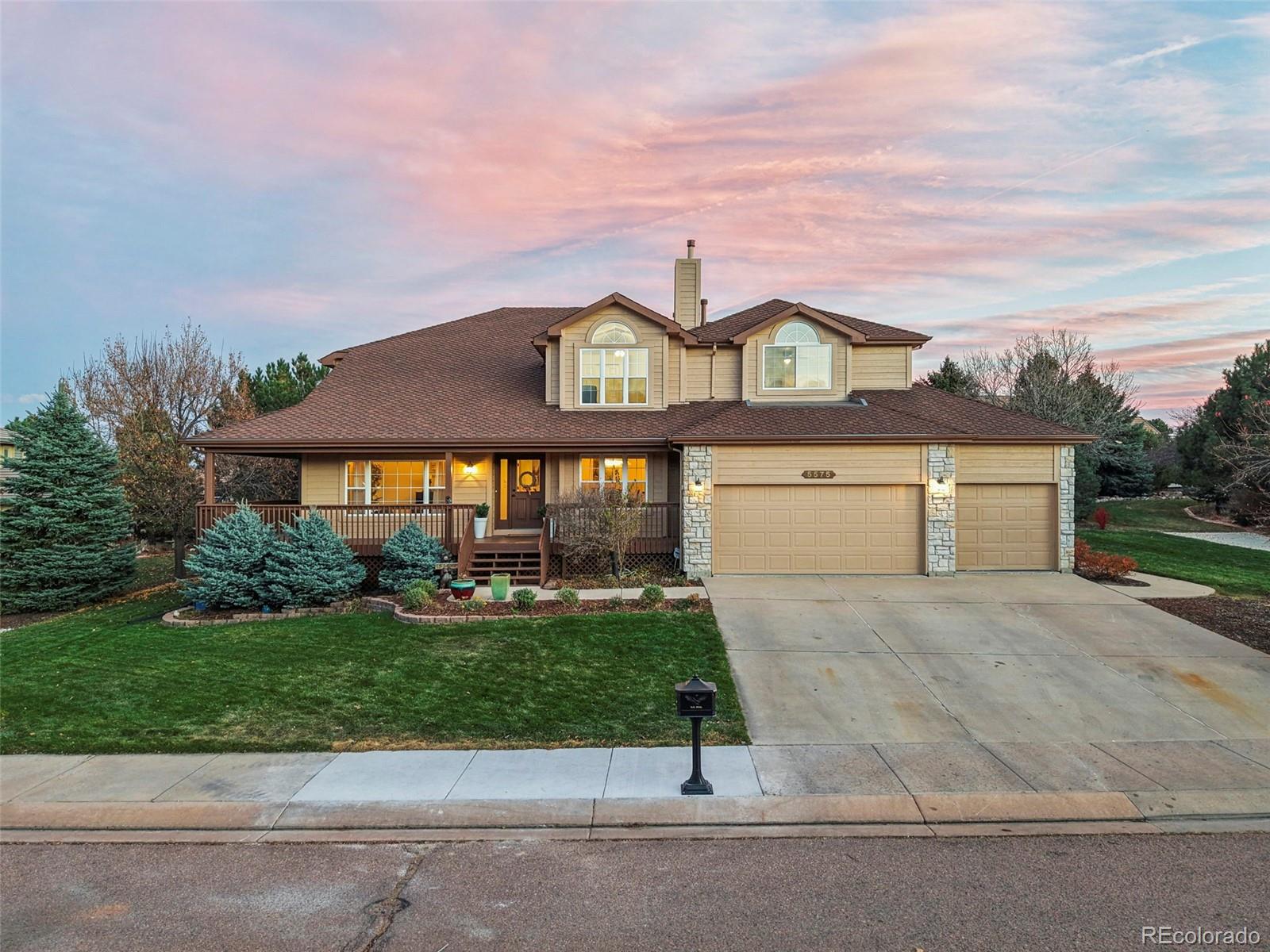 5575 Butler Court Colorado Springs, CO 80918 - Photo 3 of 47 a front view of a house with a yard and garage