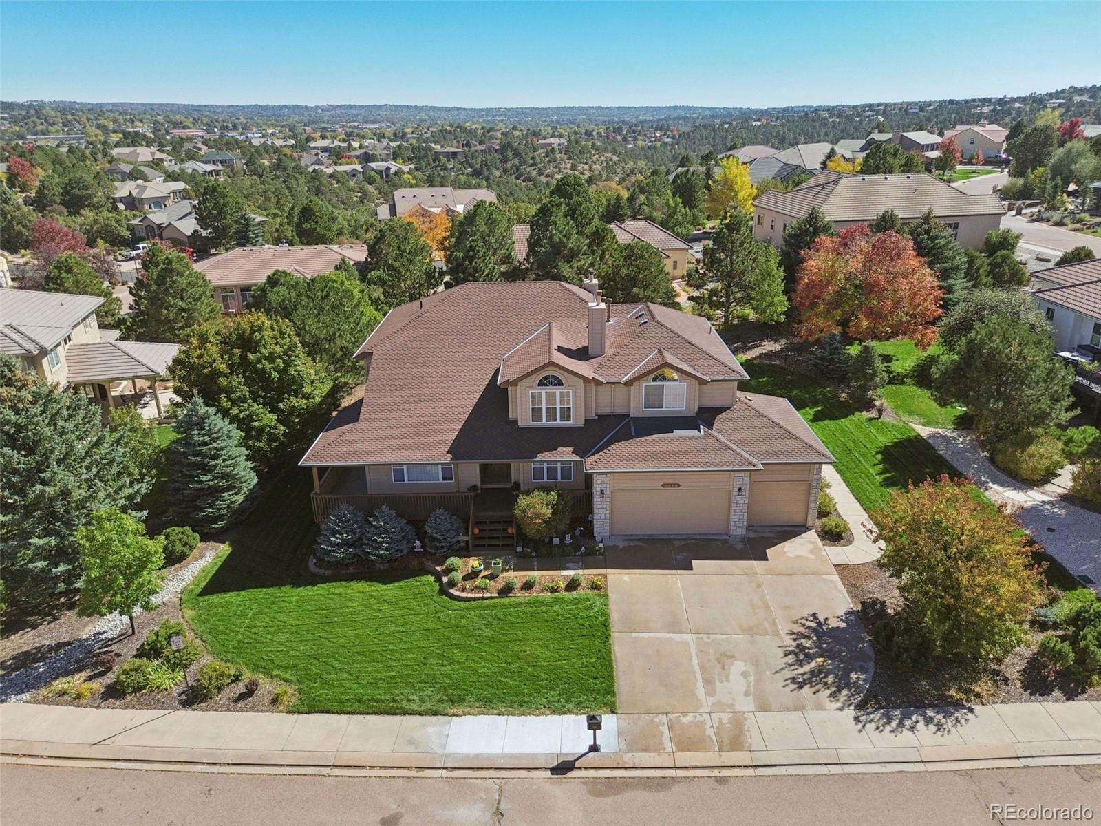 5575 Butler Court Colorado Springs, CO 80918 - Photo 32 of 47 an aerial view of a house with a garden and trees
