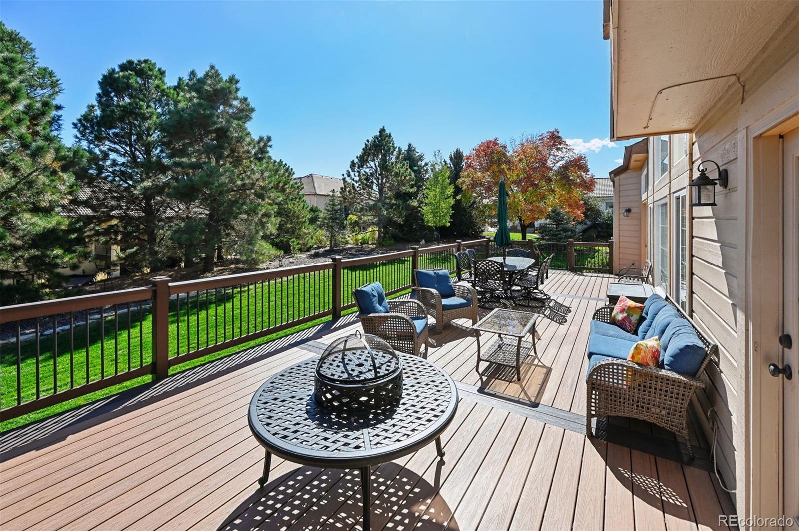 5575 Butler Court Colorado Springs, CO 80918 - Photo 33 of 47 a view of a patio with couches chairs potted plants and a wooden floor