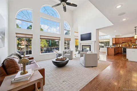 a living room with fireplace furniture and a large window