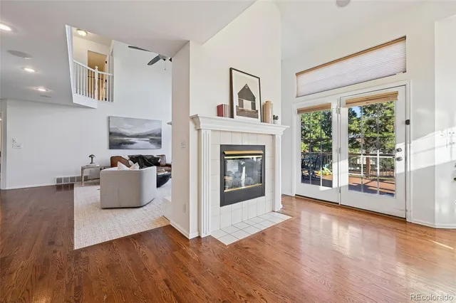 a living room with furniture wooden floor and a fireplace