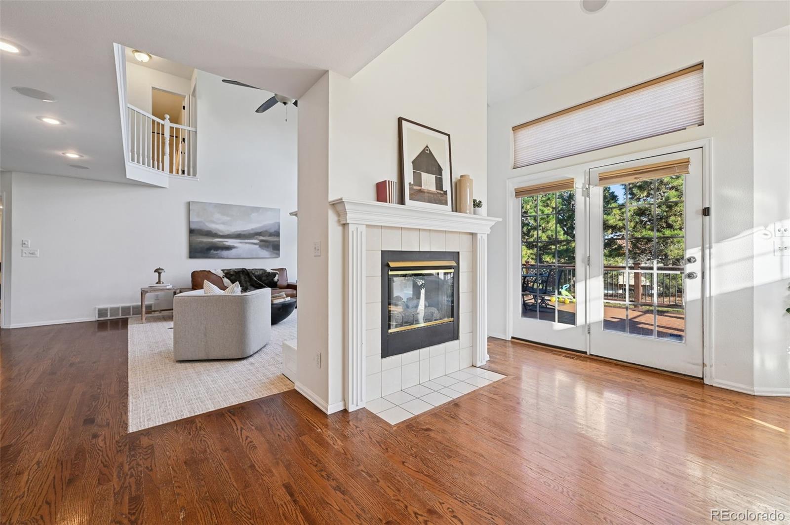 5575 Butler Court Colorado Springs, CO 80918 - Photo 10 of 47 a living room with furniture wooden floor and a fireplace