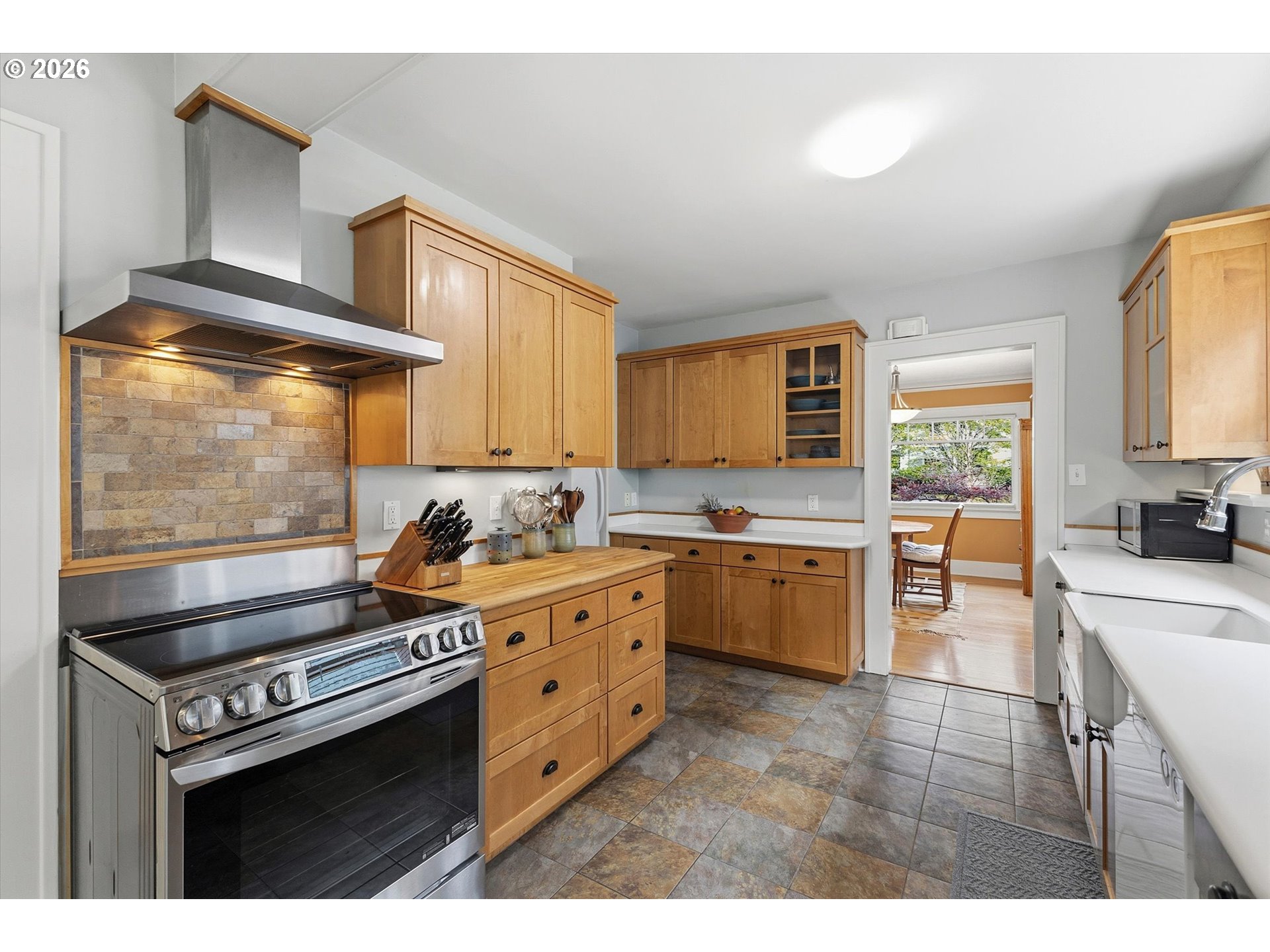 3613 Northeast 24th Avenue Portland, OR 97212 - Photo 11 of 48 a kitchen with stainless steel appliances a stove a sink dishwasher and cabinets with wooden floor