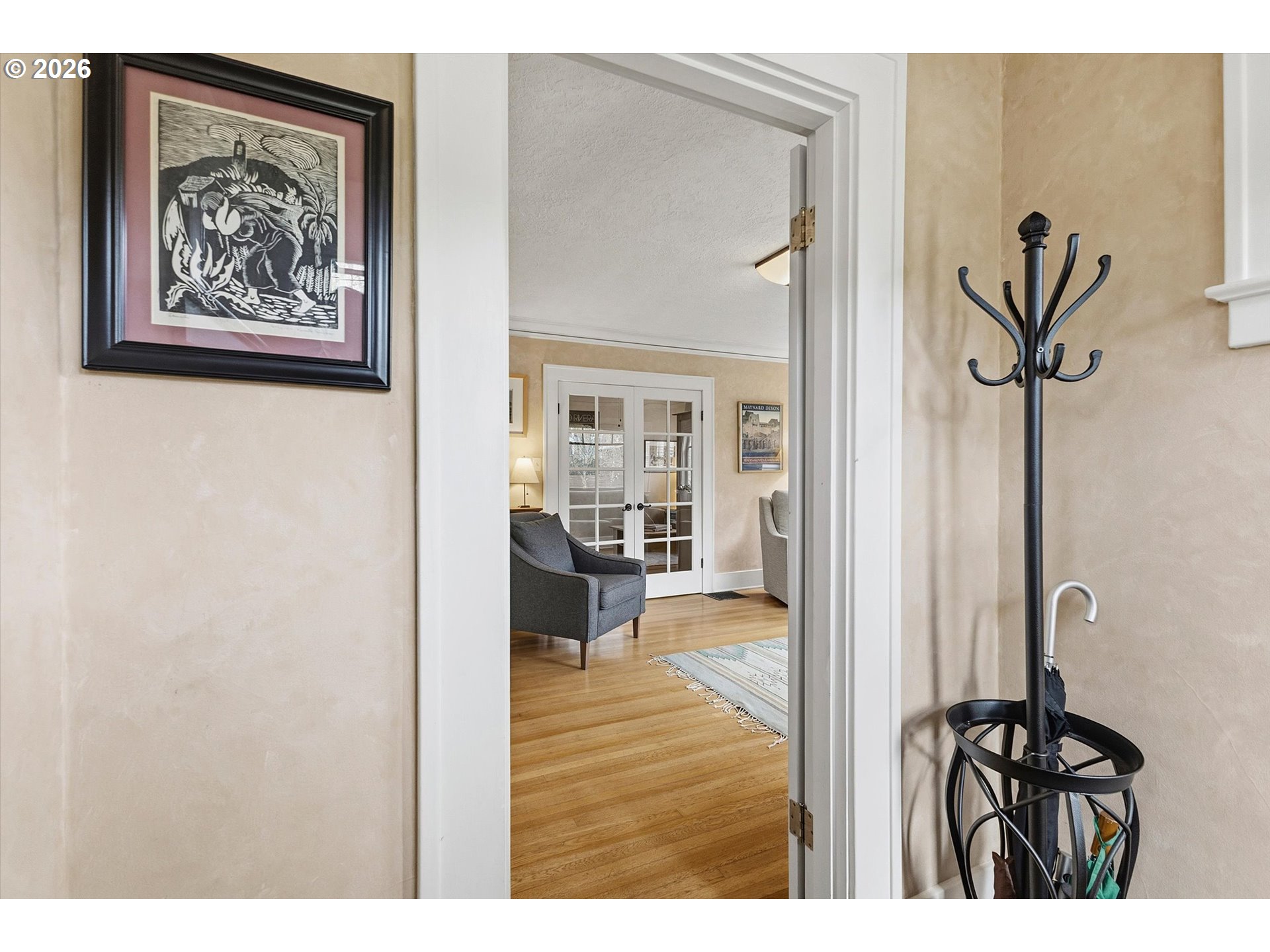 3613 Northeast 24th Avenue Portland, OR 97212 - Photo 2 of 48 a view of a hallway with a potted plant on a table and a painting on the wall
