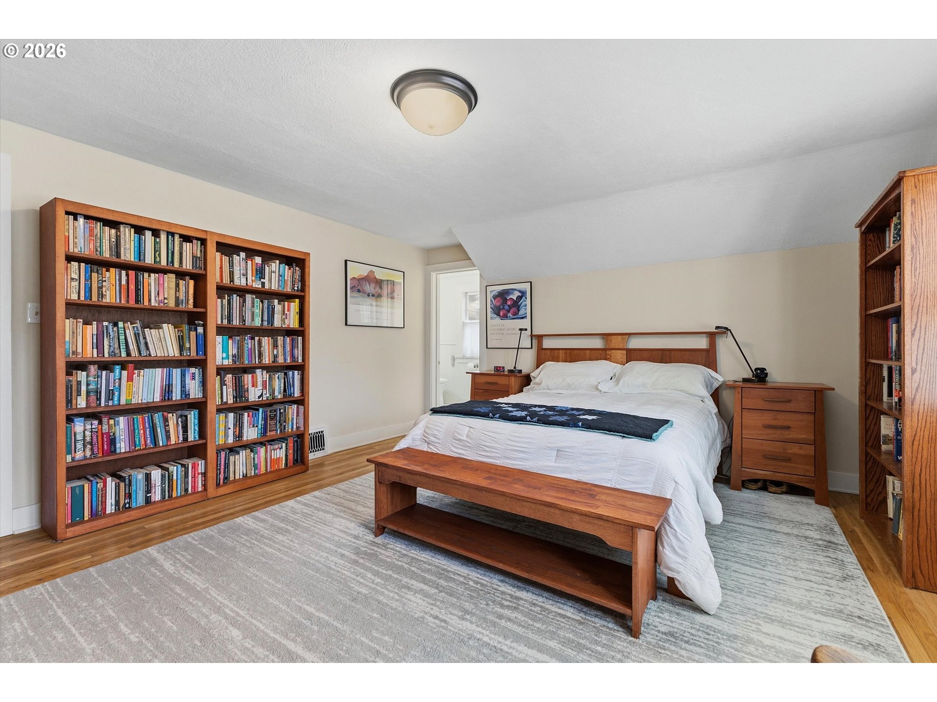 3613 Northeast 24th Avenue Portland, OR 97212 - Photo 22 of 48 a bedroom with a bed and a book shelf