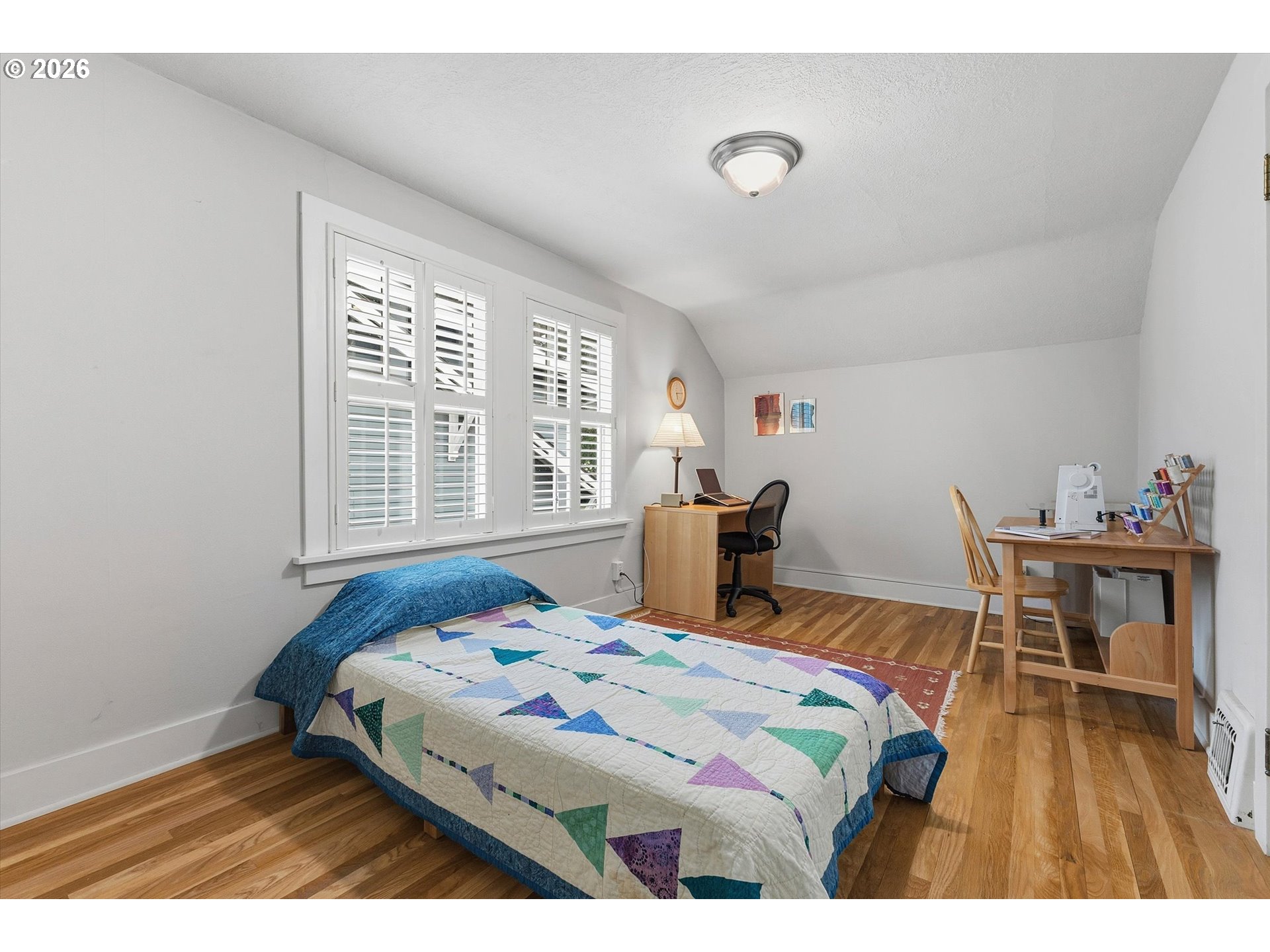 3613 Northeast 24th Avenue Portland, OR 97212 - Photo 27 of 48 a bedroom with a bed and a table in it