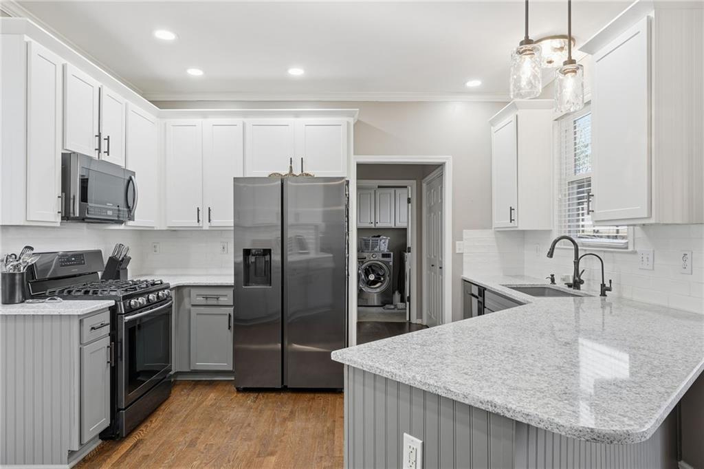 112 Willow View Lane Canton, GA 30114 - Photo 12 of 50 a kitchen with stainless steel appliances granite countertop a sink stove and refrigerator