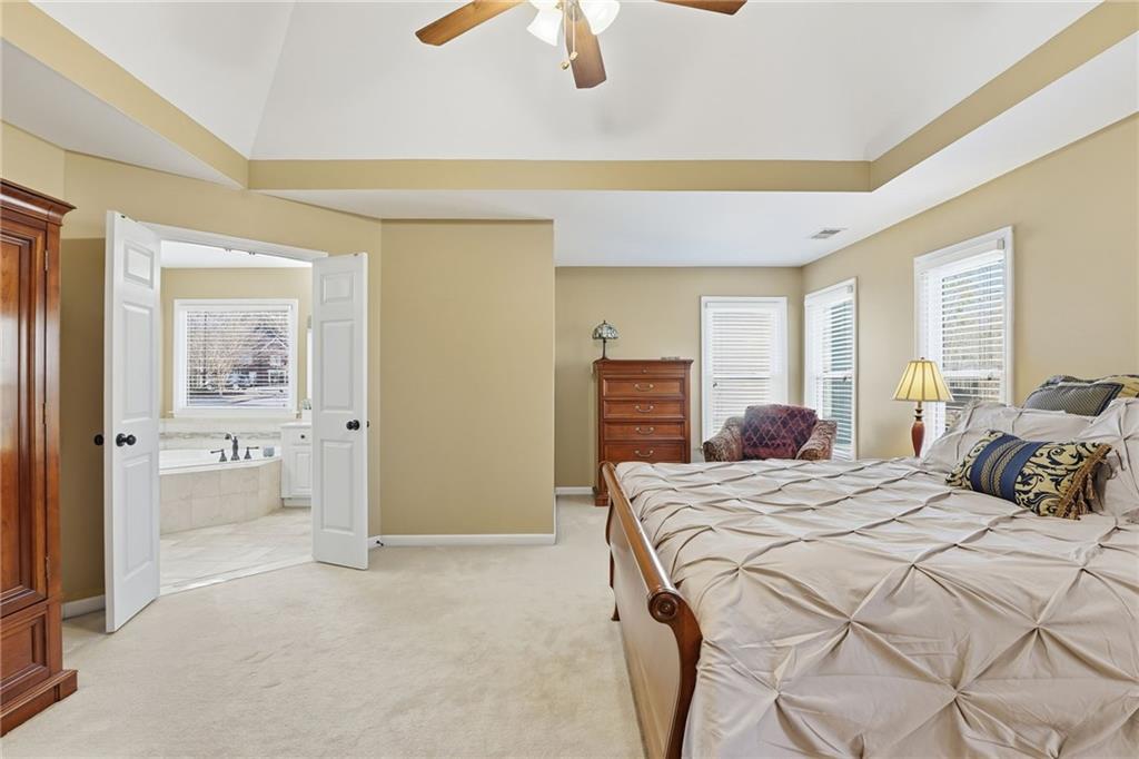 112 Willow View Lane Canton, GA 30114 - Photo 29 of 50 a bedroom with a bed and a chandelier