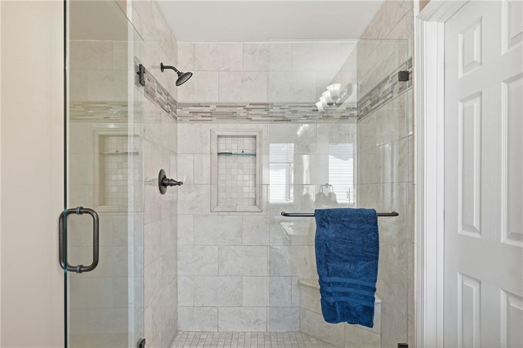 112 Willow View Lane Canton, GA 30114 - Photo 33 of 50 a bathroom with a granite countertop shower a mirror and a shower