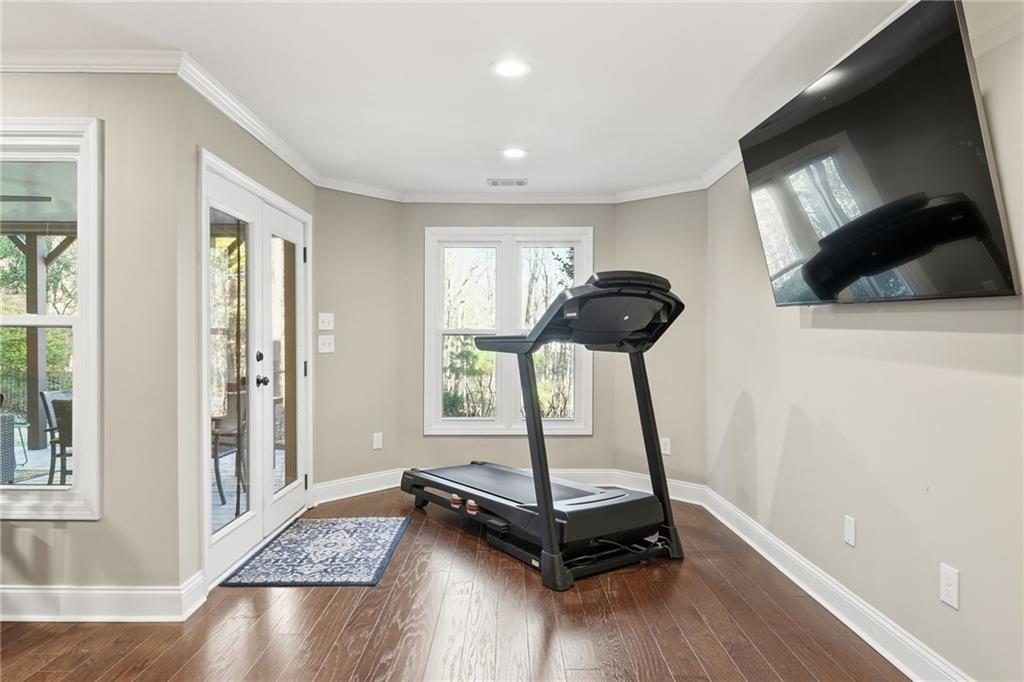 112 Willow View Lane Canton, GA 30114 - Photo 40 of 50 a room with gym equipment and a flat screen tv