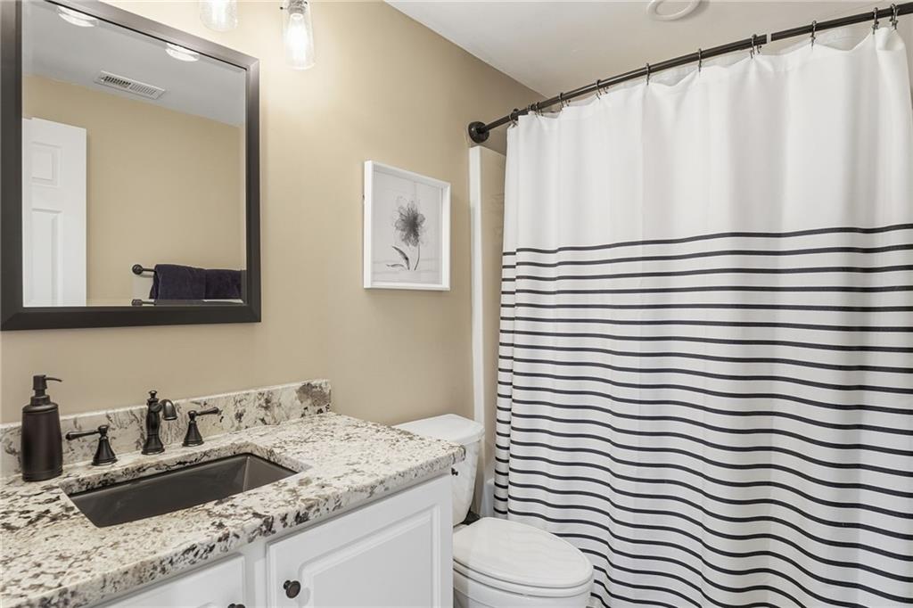 112 Willow View Lane Canton, GA 30114 - Photo 43 of 50 a bathroom with a granite countertop sink vanity mirror and toilet