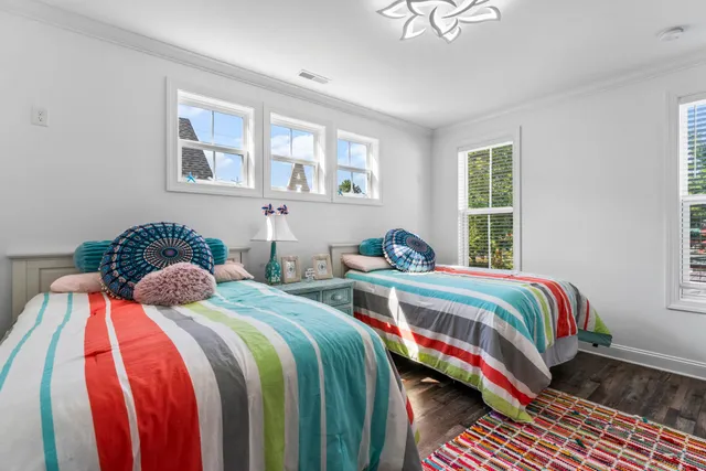 a living room with furniture a flat screen tv and kitchen view