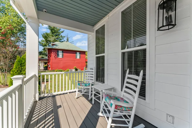 a front view of a house with a yard and potted plants
