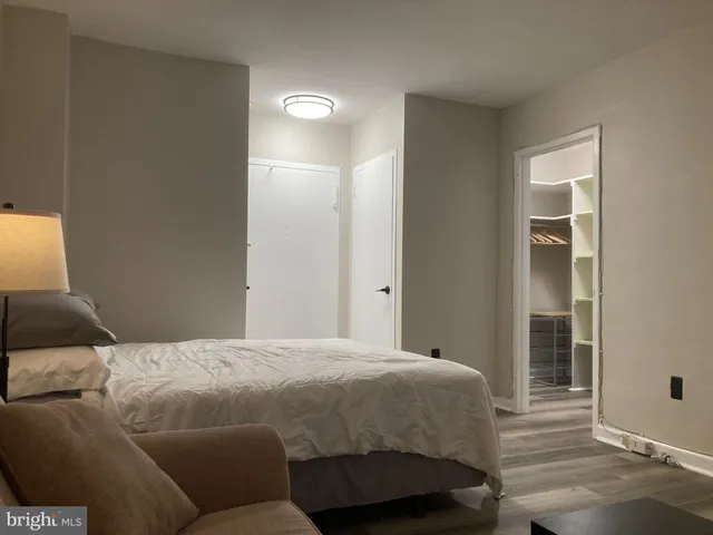 a living room with a couch and a lamp