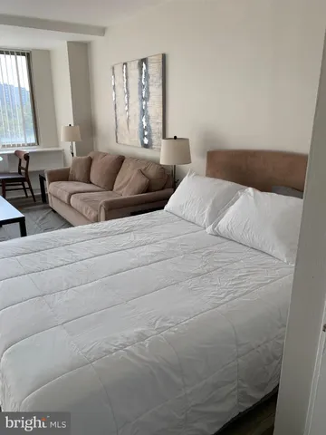 a bedroom with a bed and window