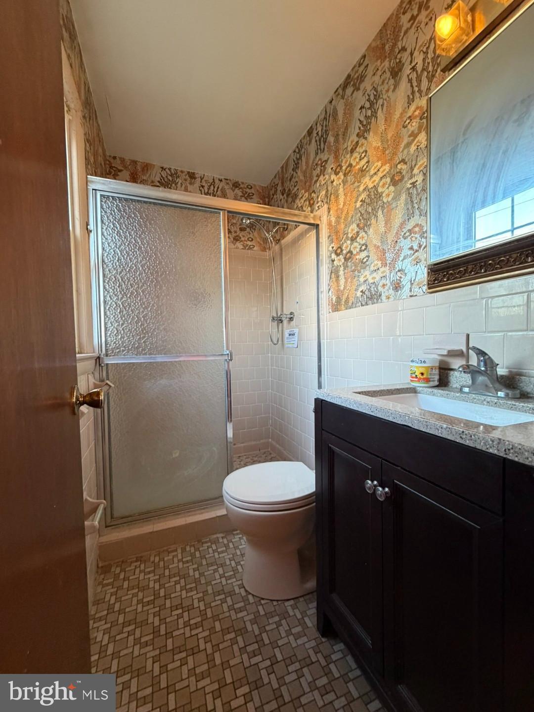27 Haines Avenue Rising Sun, MD 21911 - Photo 13 of 32 a bathroom with a granite countertop toilet a sink and a shower