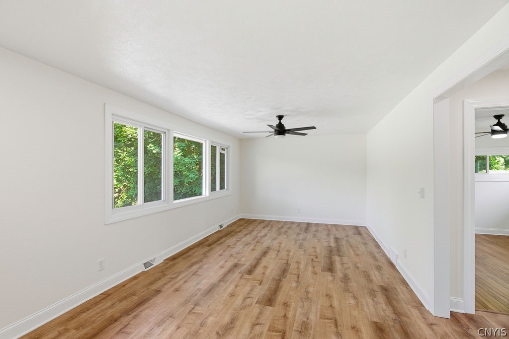 7016 Guyder Road Lysander, NY 13112 - Photo 11 of 41 1st floor family room, the flooring is fantastic!