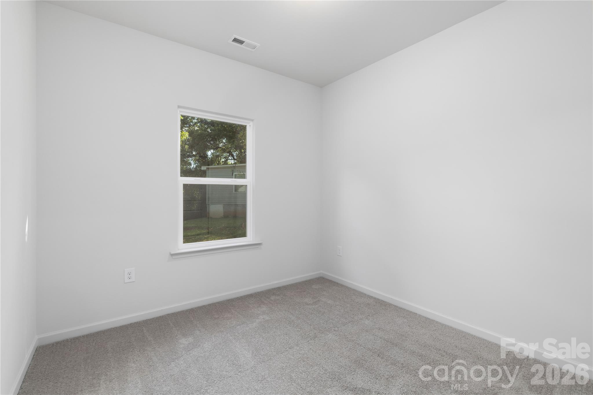 6924 Ridge Ln Road Charlotte, NC 28262 - Photo 20 of 24 an empty room with a window