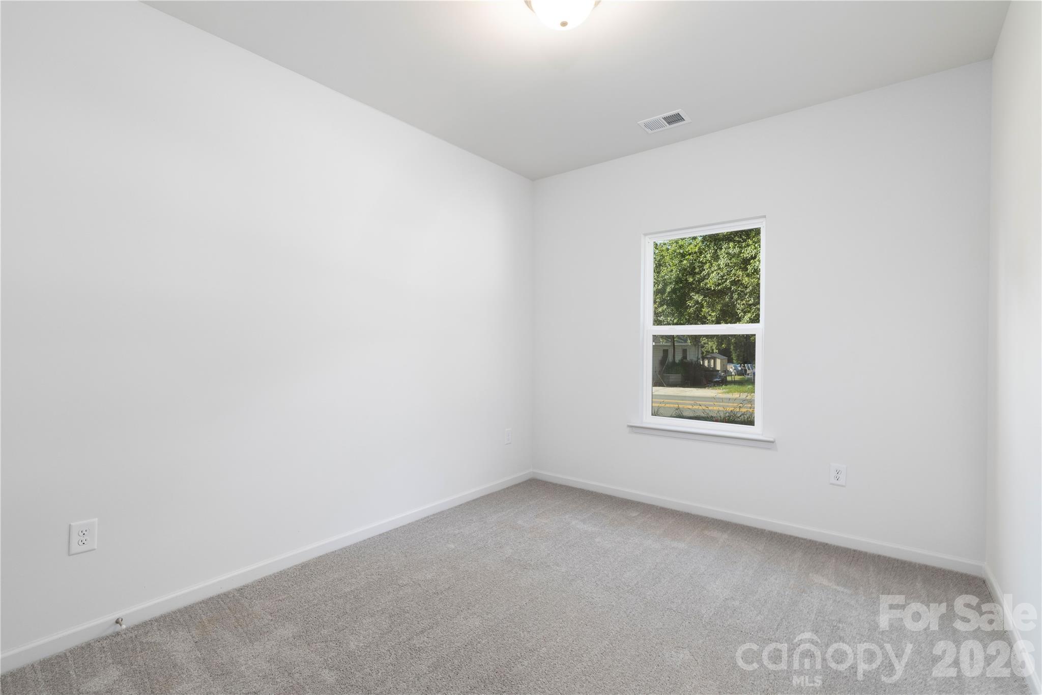 6924 Ridge Ln Road Charlotte, NC 28262 - Photo 21 of 24 an empty room with a window