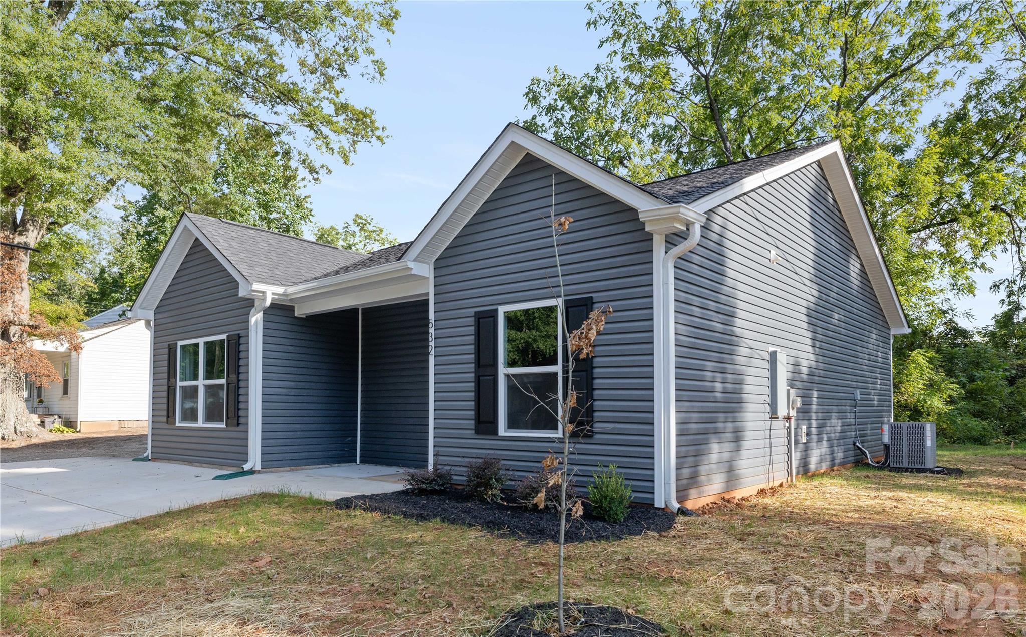 6924 Ridge Ln Road Charlotte, NC 28262 - Photo 3 of 24 a front view of a house with garden