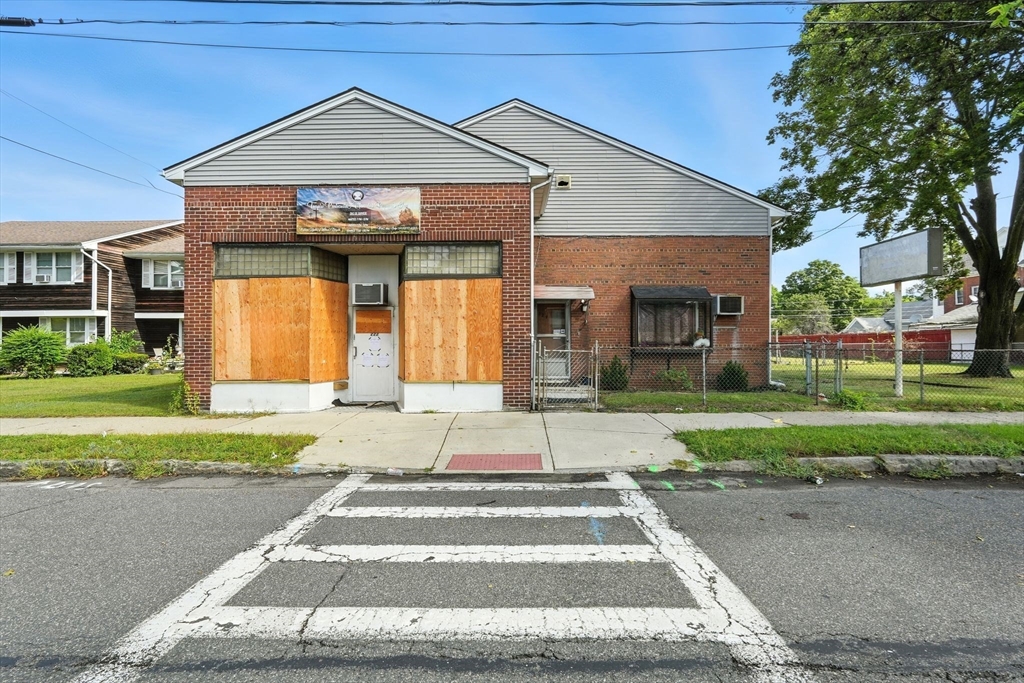 222-224 Main Street Springfield, MA 01151 - Photo 1 of 42 a front view of a house with a yard and garage