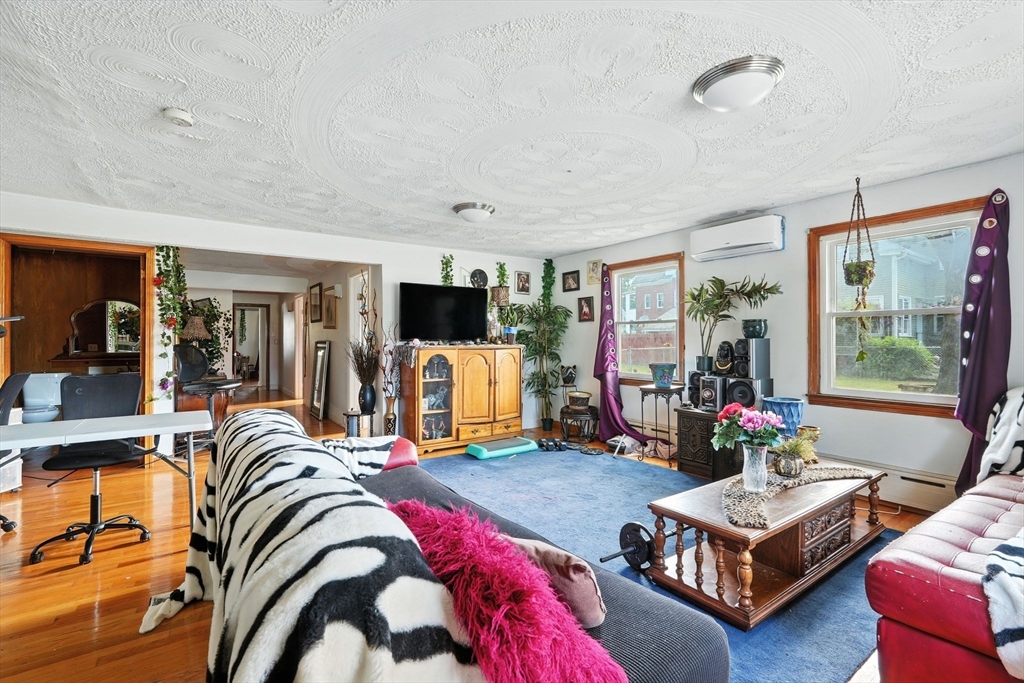 222-224 Main Street Springfield, MA 01151 - Photo 13 of 42 a living room with furniture flat screen tv and a large window