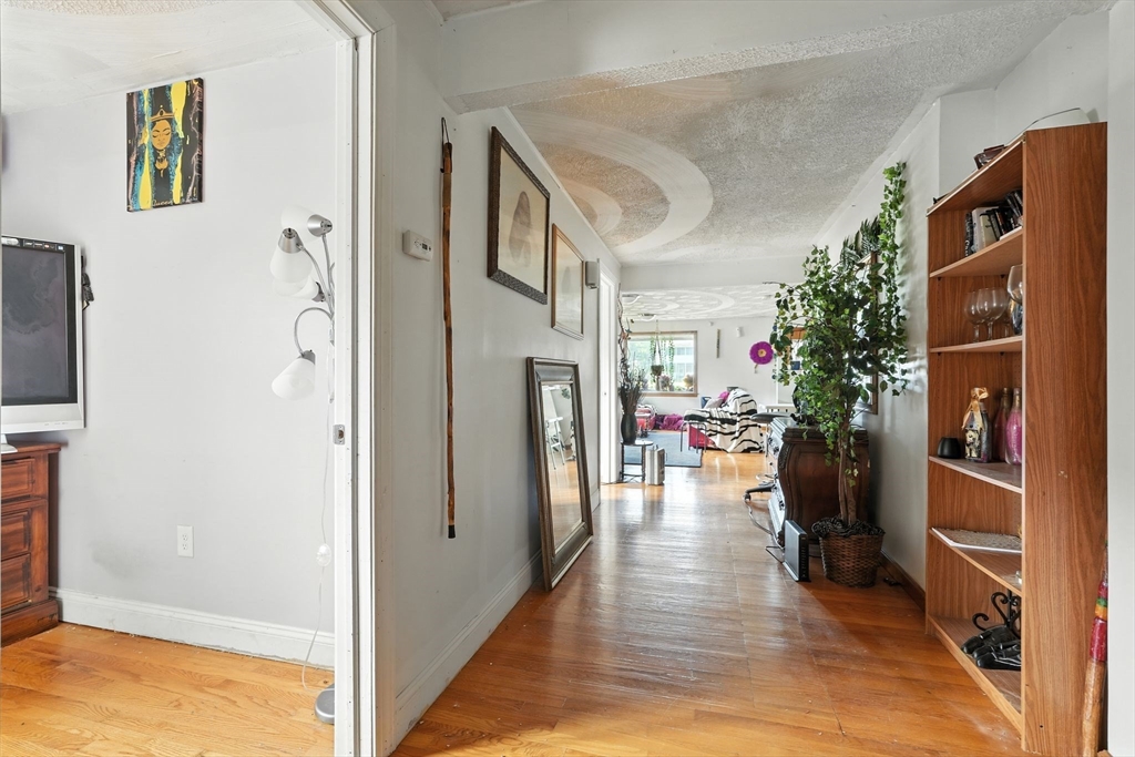 222-224 Main Street Springfield, MA 01151 - Photo 14 of 42 a view of a hallway view with living room and wooden floor